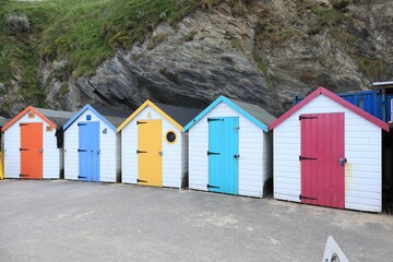 several different colored beach huts are next to each other in a row