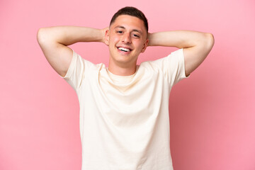 Young Brazilian man isolated on pink background laughing