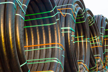 Huge new electrical cables tied into spools, close-up.