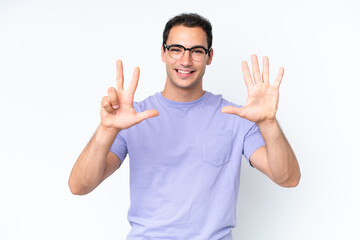 Young caucasian man isolated on white background counting eight with fingers