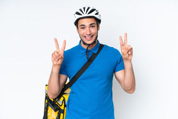 Young caucasian man with thermal backpack isolated on white background showing victory sign with both hands