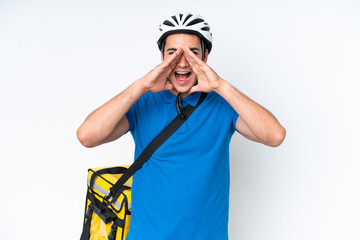 Young caucasian man with thermal backpack isolated on white background shouting and announcing something