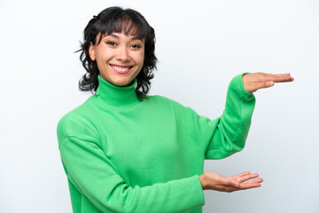 Young Argentinian woman isolated on white background holding copyspace to insert an ad