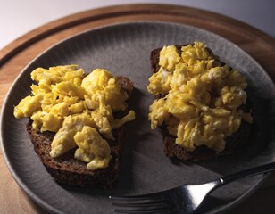 Closeup of scrambled eggs with cheese on a plate