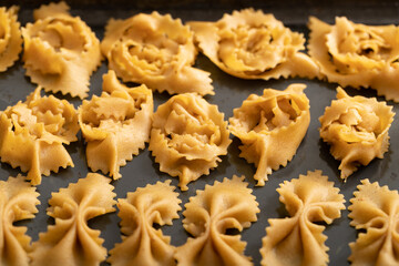 Zooming into culinary finesse: the delicate touch of hands crafting chebakia dough into delightful, unique shapes