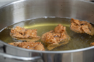 the frying phase of chebakia brings excitement as each piece achieves crispy perfection