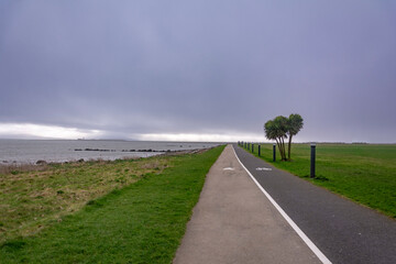 A storm is coming over the footpath by the shore