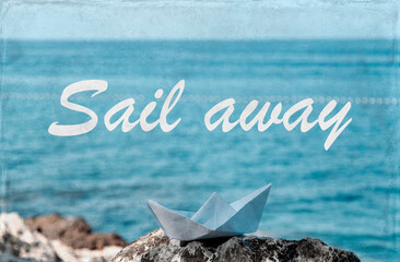 Paper boat on the rocks by the sea, travel concept vintage style