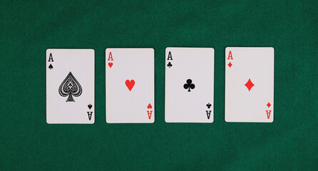 four card aces isolated on green table