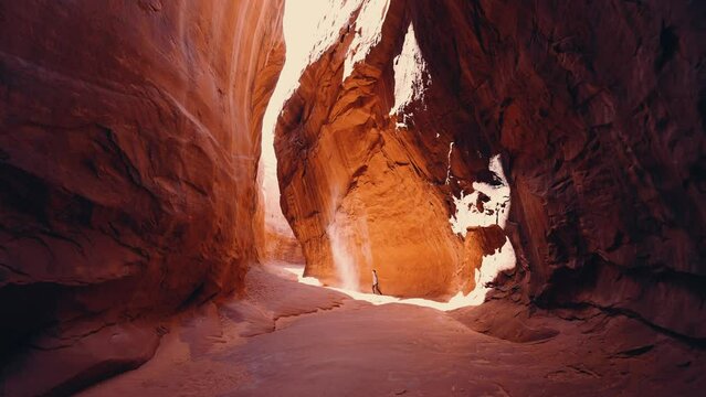 Wide shot of person walking in Utah slot canyon