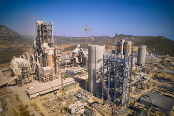 Structures of cement producing plant. Aerial view of huge industrial factory. 