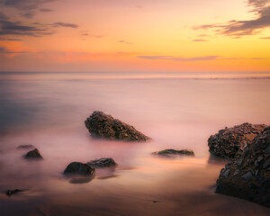brown sea rocks at amazing sunset sky