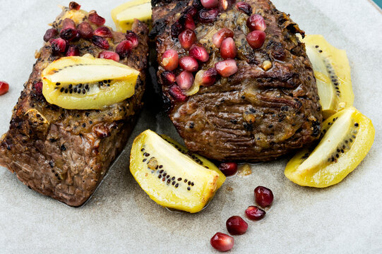 Beef meat baked with kiwi and pomegranate.