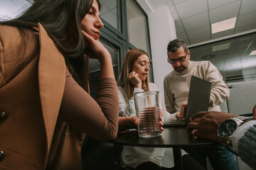 Side view shot of good looking middle-aged business person helping his junior coworkers at the office with their daily tasks at work