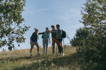 Fototapeta na wymiar Four sporty friends making a deal before they keep hiking