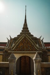 Fototapeta na wymiar Vertical shot of the Grand Palace in the streets of Bangkok, Thailand during the day
