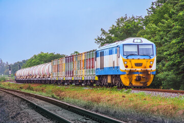 Freight train by diesel locomotive on the railway.