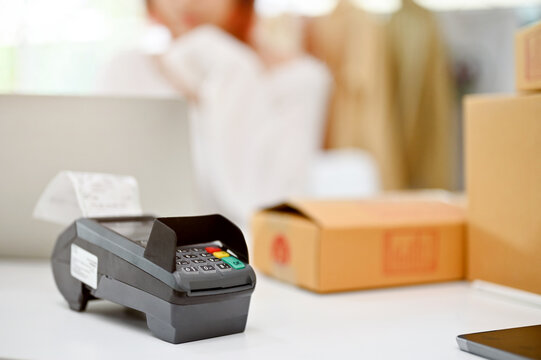Close-up image of a card reader machine or POS terminal machine on a table.
