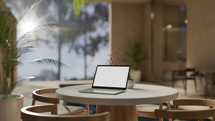 Laptop mockup on a table in modern contemporary living room with large window.