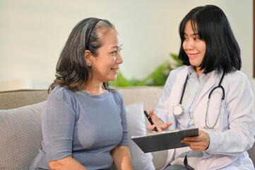 Attractive senior Asian woman is discussing her medical treatment plan with a doctor