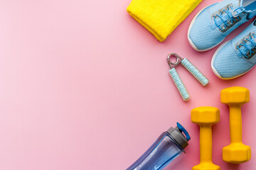 Sport fitness flatlay with sneakers and dumbbells, top view