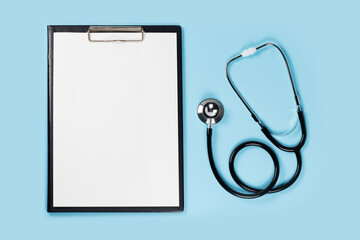 Blank clipboard with stethoscope on blue background