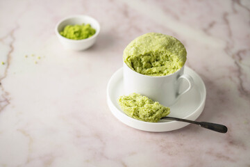 Matcha cupcake in a white mug. Easy homemade dessert. Mugcake