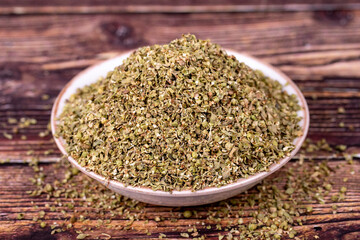 Thyme spice. Dried Thyme leaf in bowl on wood background. Spice concept.