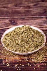 Thyme spice. Dried Thyme leaf in bowl on wood background. Spice concept.
