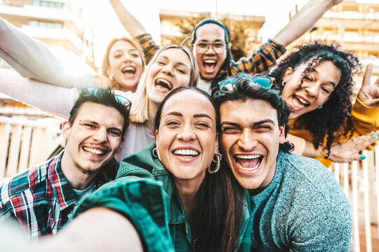 Happy multiracial friends taking selfie pic outside - Cheerful young people smiling together at camera - Life style concept with guys and girls hanging out on summer vacation - Bright filter