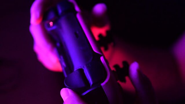Gamer hands playing a game with gamepad. Close up.