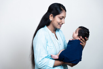 Young indian mother with cute newborn son in her arms. Loving asian mom hold small baby child, Beautiful family, Motherhood. mother's day concept.