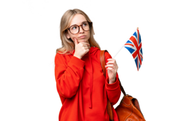 Young hispanic woman holding an United Kingdom flag over isolated background having doubts
