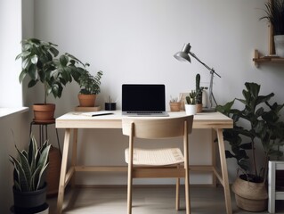 A minimalist and modern desk setup with a laptop and plants