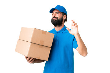 Delivery caucasian man over isolated chroma key background with fingers crossing and wishing the best