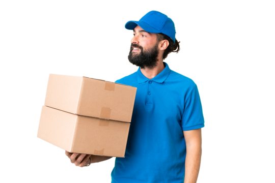 Delivery caucasian man over isolated chroma key background looking to the side and smiling