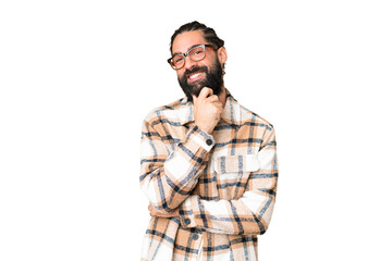 Young man with beard over isolated chroma key background with glasses and smiling