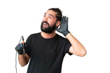 Tattoo artist caucasian man over isolated chroma key background listening to something by putting hand on the ear
