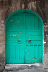 Fototapeta na wymiar Old inn doors made in the Ottoman period. Istanbul historical inn gates. Gate of an old large inn on the streets of Istanbul 