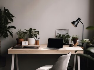 A minimalist and modern desk setup with a laptop and plants