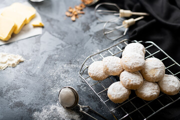 Traditional arabian cookies (kahk) sprinkled with white sugar and it's ingredients (flour, milk, butter, sugar and nuts)
