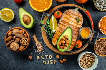 Dish grilled salmon steak with avocado and fresh vegetable salad. Keto diet concept healthy food, Healthy fats, clean eating for weight loss. top view