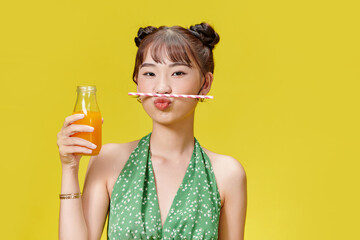 Portrait of pretty young woman holding juicy delicious orange