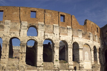 fragment of colosseum walls in dark blue sky