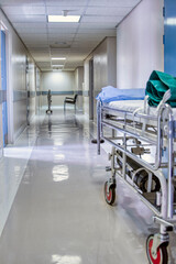 hospital bed in a long hallway,