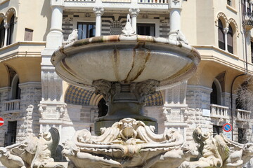 Famous stone fountain in Rome, Italy. Beautiful cityscape on a sunny summer day.