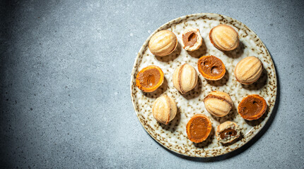 Homemade nuts cookies filled with boiled condensed milk cream on a light background. Long banner format. top view