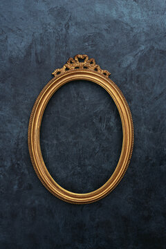Gold oval frame on a wall