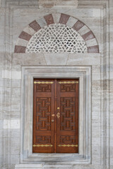 Fototapeta na wymiar Istanbul Beyazit Mosque. Wooden doors in Beyazit mosque. Wooden carved doors.
