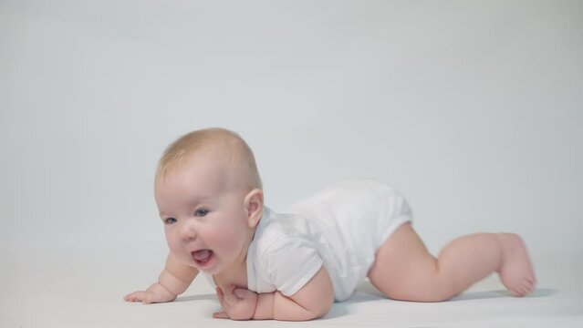infant on a white background first attempts at a mobile